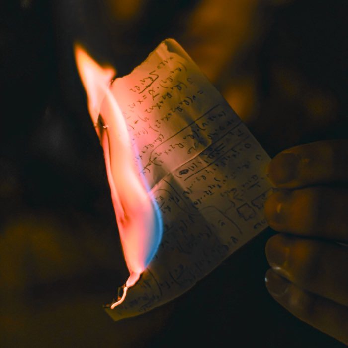 Burning sheet of paper. This image serves as a reminder of the limitations of language and the importance of letting go of fixed views in order to experience reality directly.
