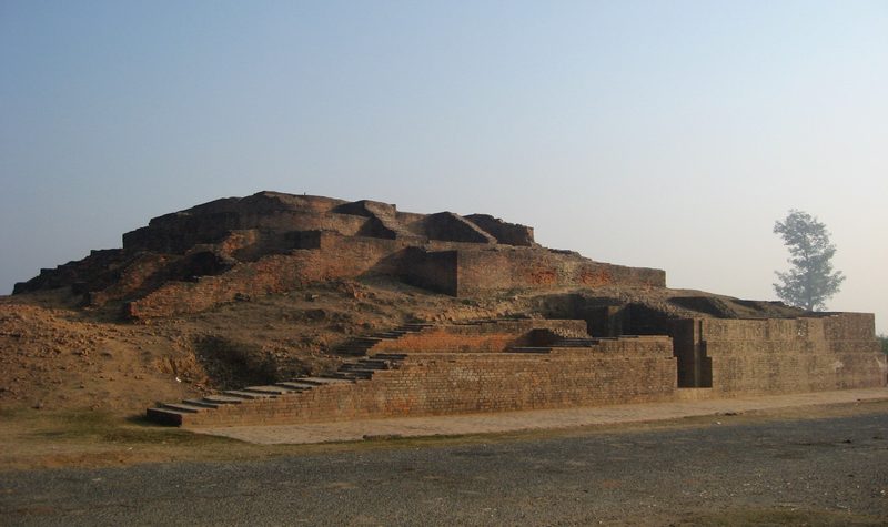View on a section of Jetavana Monastery, Sravasti, India, showing a collection of smaller stupas, with more large structures in the background.