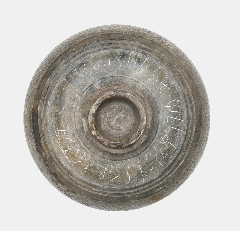 Detail view of the container's lid with the inscriptions.