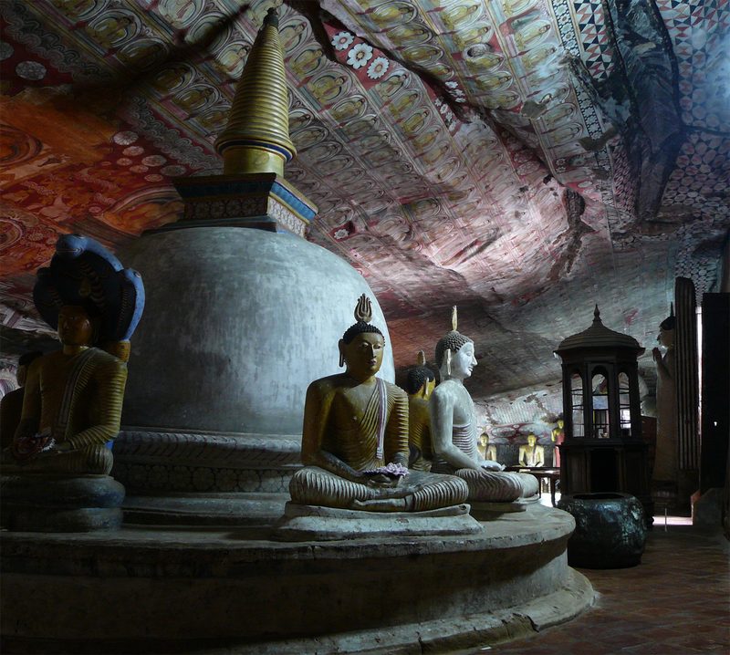 Stupa with sitting Buddhas around it, in the Dambulla complex of cave monasteries. Sri Lanka.