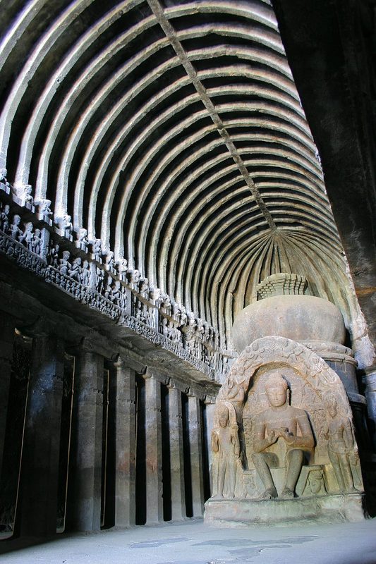 A hall of of the Ellora cage temple (cave 10) with bell-shaped stupa in the apse.