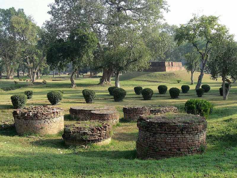 View on a section of Jetavana Monastery, Sravasti, India, showing a collection of smaller stupas, with more large structures in the background.