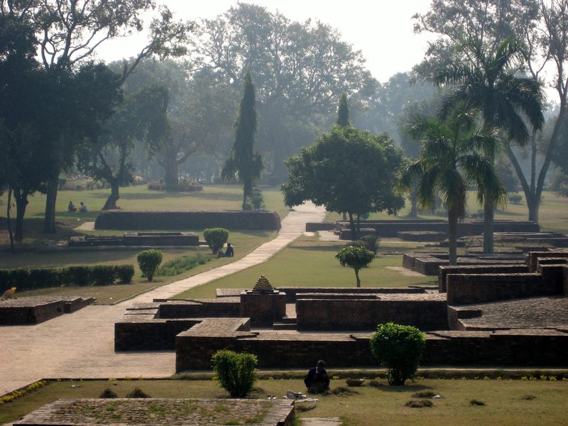 View on a section of Jetavana Monastery, Sravasti, India, showing part (the entry) of the Mulagandhakuti, and the Anandabodhi tree in the background.
