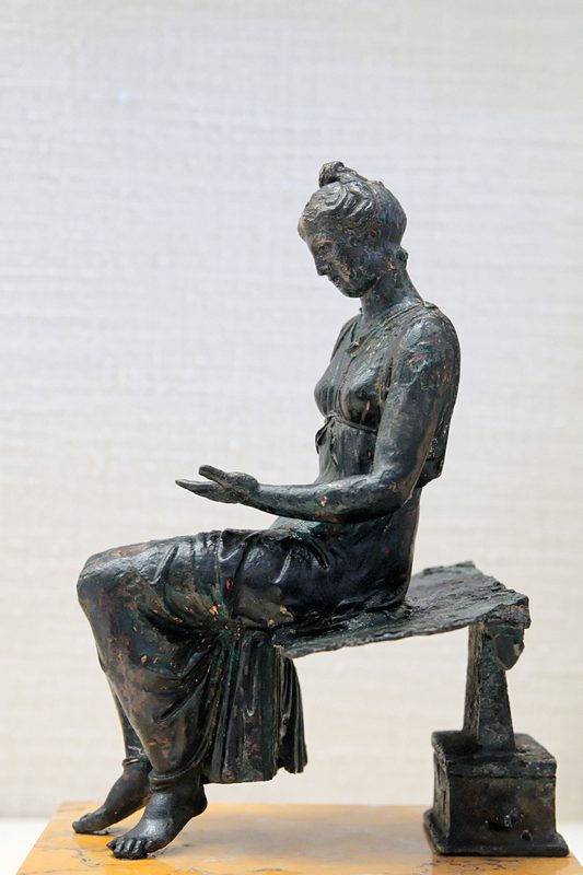 Bronze statuette of a girl reading (1st century CE).