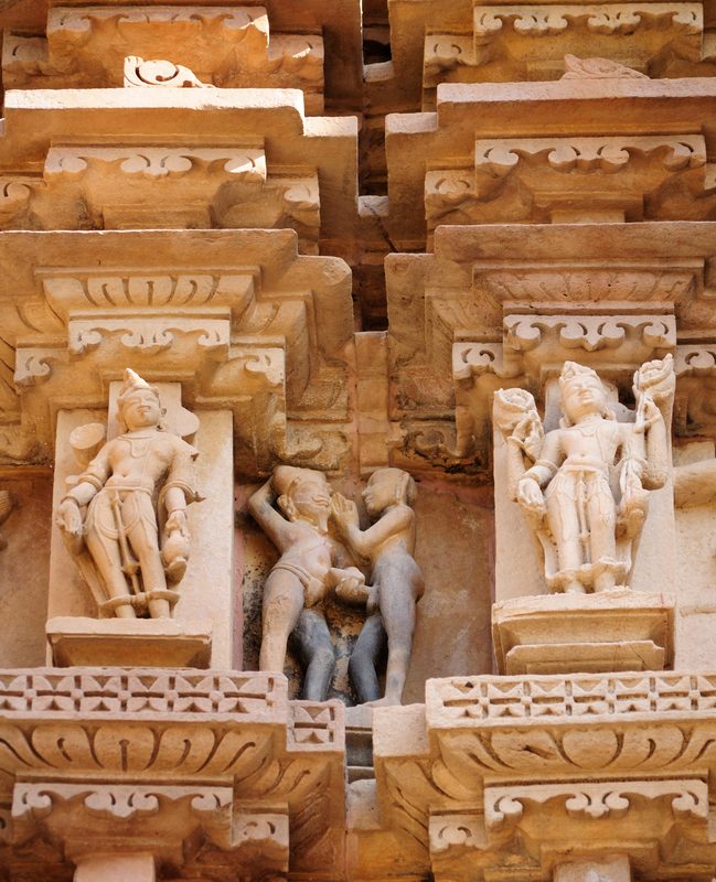 Khajoraho scene where one man reaches out to another's erect penis.