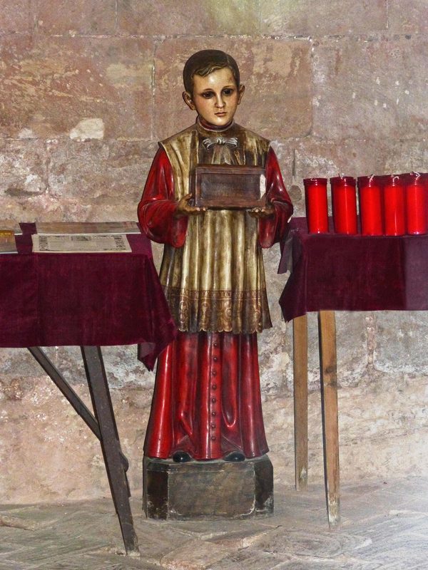 Statue of an altar boy in a church.
