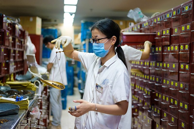 Apothecary mixing traditional Chinese medicine at Jiangsu Chinese Medical Hospital, Nanjing, China.