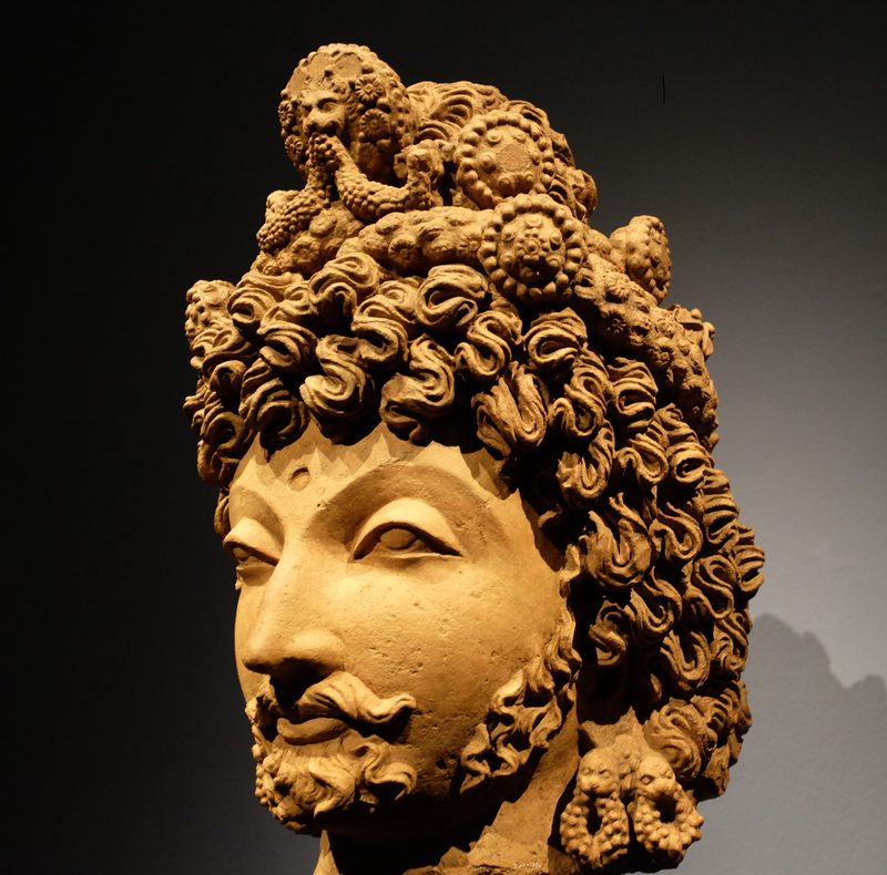 Head of a bodhisattva, Gandhara, around 4th century, terracotta, Asian Civilisations Museum.