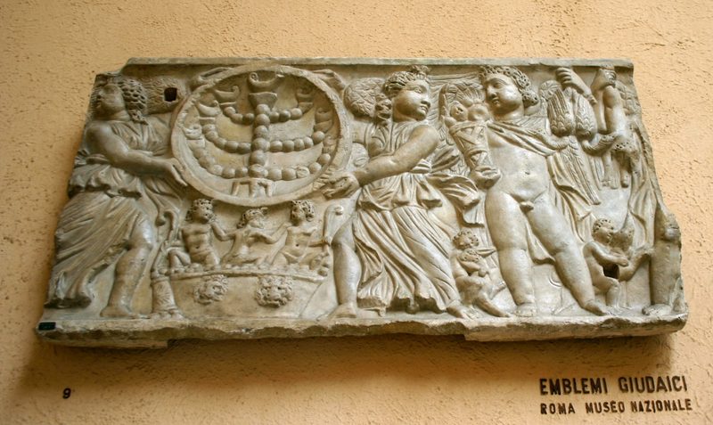 2nd or 3rd-century carving of the Menorah being attended by angels, including angels who may represent the seasons of the year.
