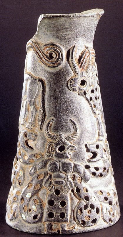 A carved chlorite vase decorated with a relief depicting a 'two-horned' figure wrestling with serpent goddesses.