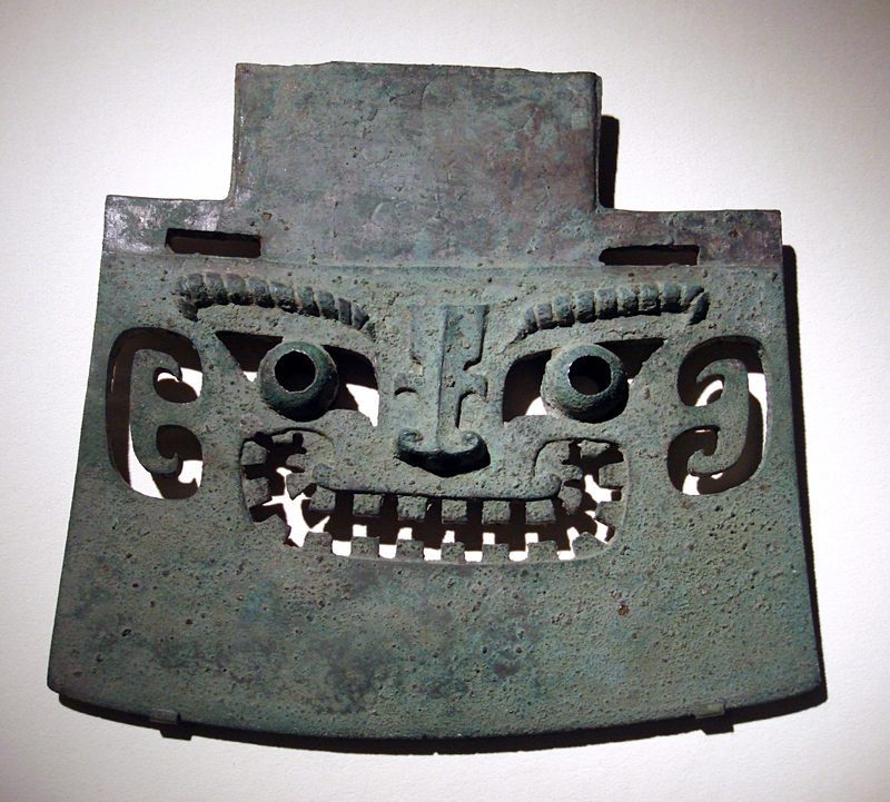 A yue bronze axe with head motif, dated to the Shang.
