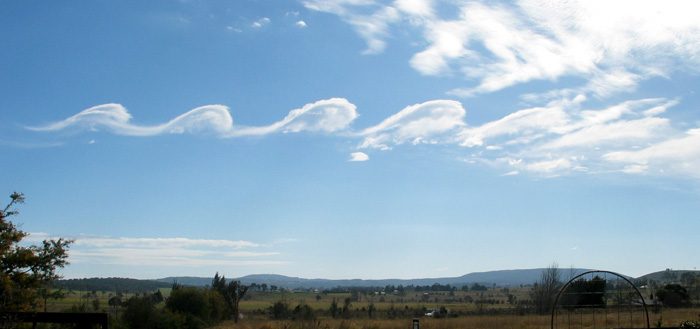 A Kelvin-Helmholtz instability rendered visible by clouds, known as fluctus, over Mount Duval in Australia.