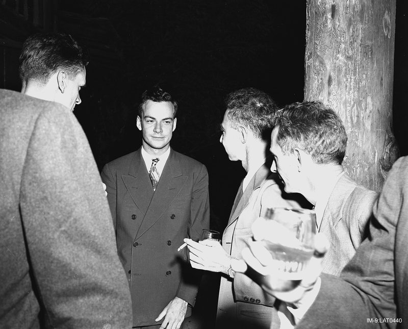 Feynman (center) with Robert Oppenheimer (immediately right of Feynman) at a Los Alamos Laboratory social function during the Manhattan Project, between 1943 and 1946.